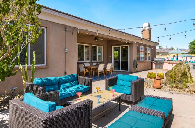 a view of a patio with couches chairs and potted plants