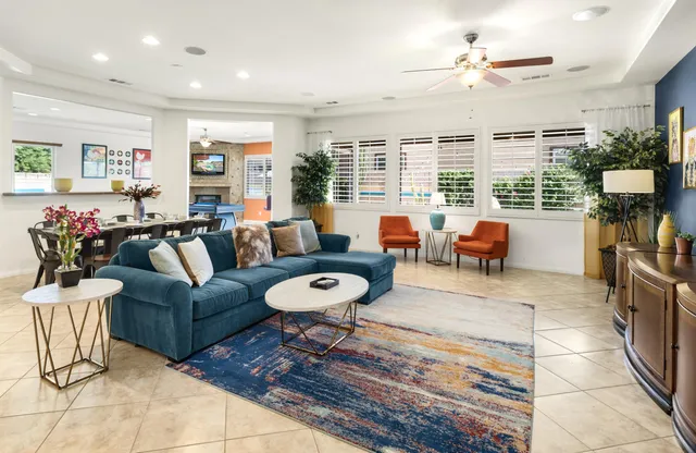 a living room with furniture potted plant and a large window