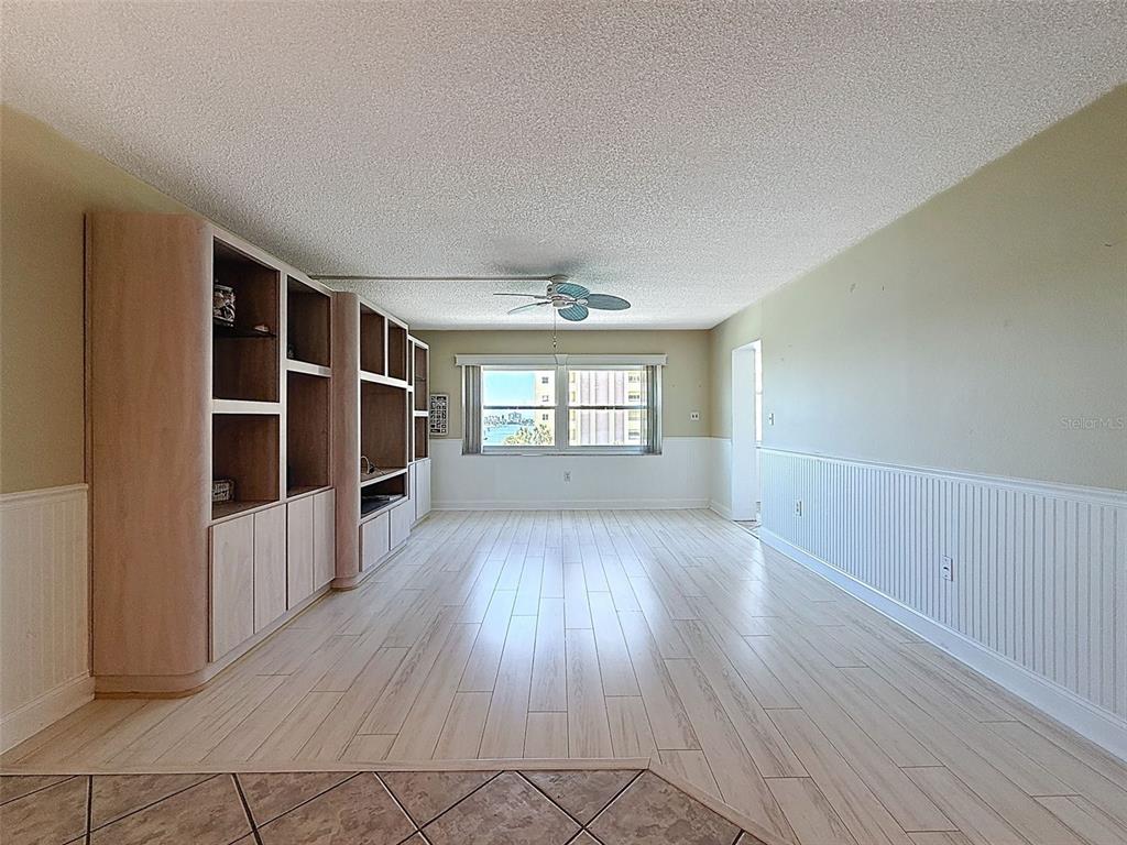 4550 Cove Circle, Unit 507 St. Petersburg, FL 33708 - Photo 11 of 32 wooden floor in an empty room with a window