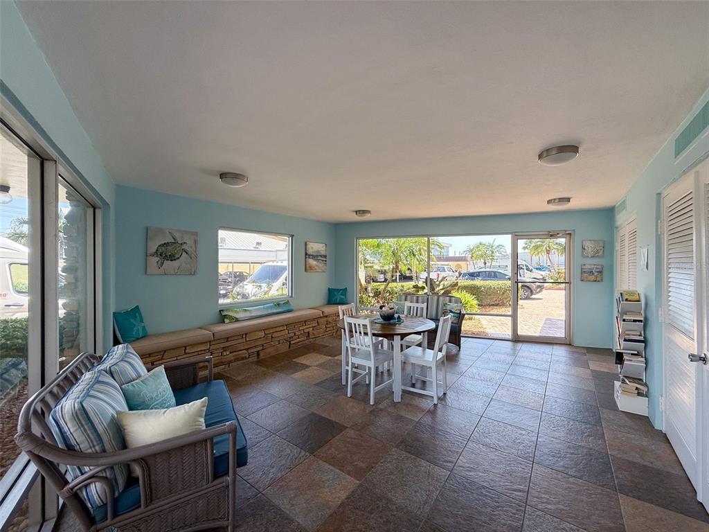 4550 Cove Circle, Unit 507 St. Petersburg, FL 33708 - Photo 27 of 32 a living room with furniture and large windows
