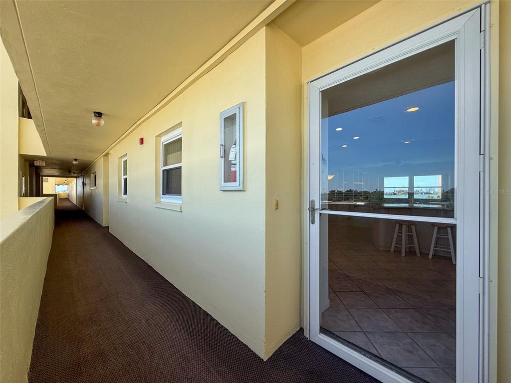 4550 Cove Circle, Unit 507 St. Petersburg, FL 33708 - Photo 4 of 32 a view of a hallway with wooden floor