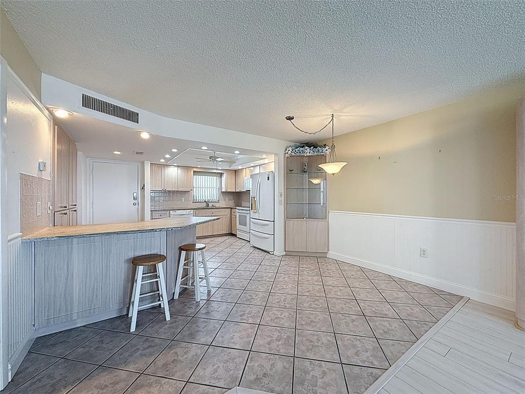 4550 Cove Circle, Unit 507 St. Petersburg, FL 33708 - Photo 7 of 32 a view of kitchen with table and chairs