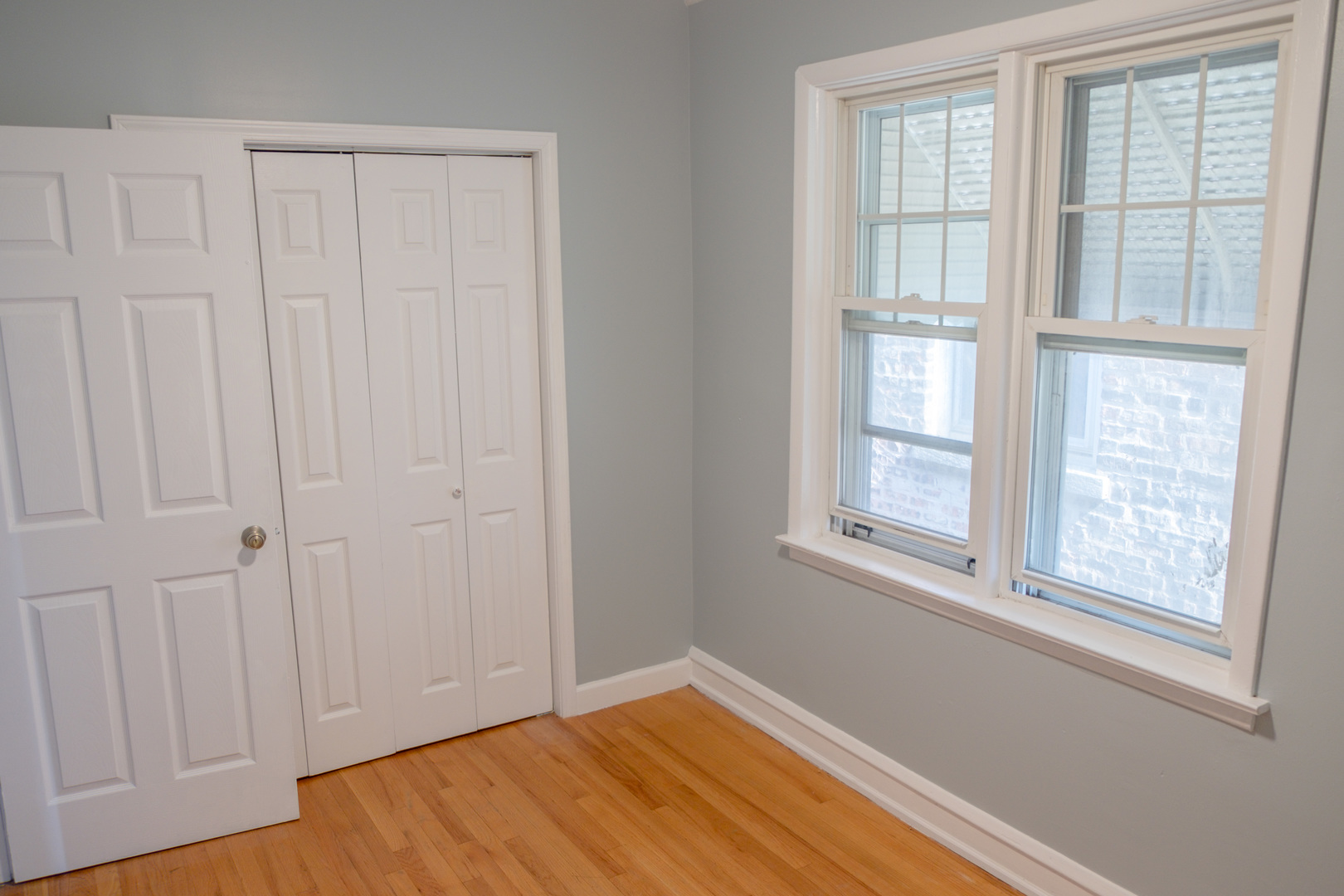 5445 West 64th Street, Unit 2 Chicago, IL 60638 - Photo 12 of 37 an empty room with wooden floor and windows
