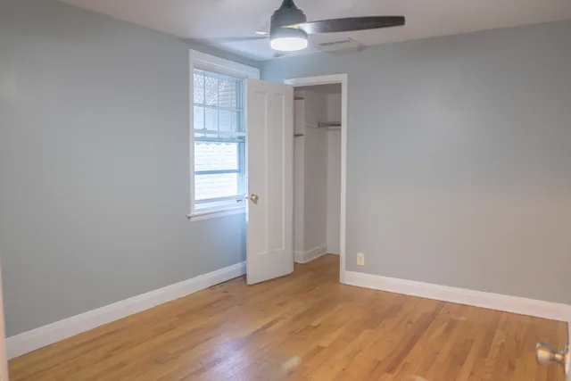 a view of a room with wooden floor