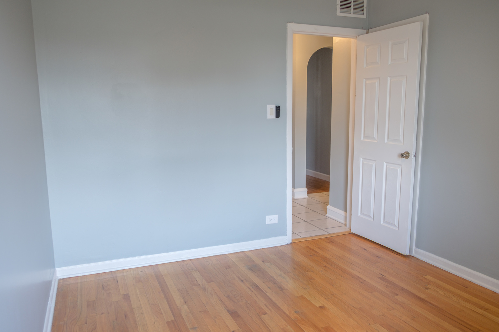 5445 West 64th Street, Unit 2 Chicago, IL 60638 - Photo 22 of 37 a view of an empty room with wooden floor and a window