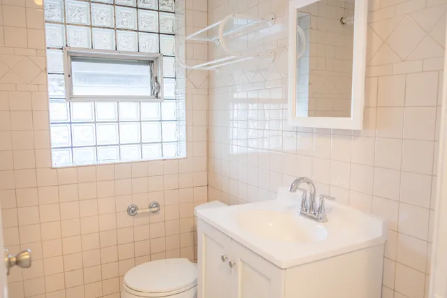 a bathroom with a toilet a sink and a shower