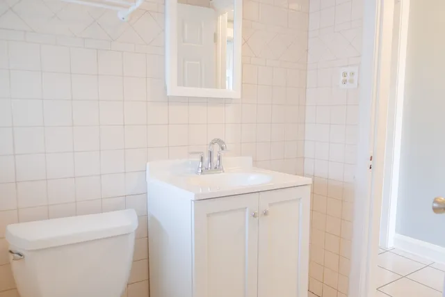 a view of a kitchen that shows a sink hardwood floor and a chandelier