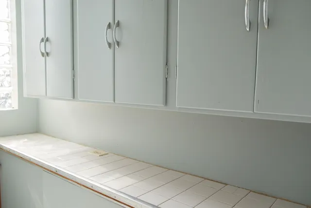 a kitchen with a stove sink and cabinets