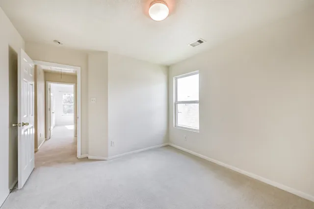 an empty room with windows and closet