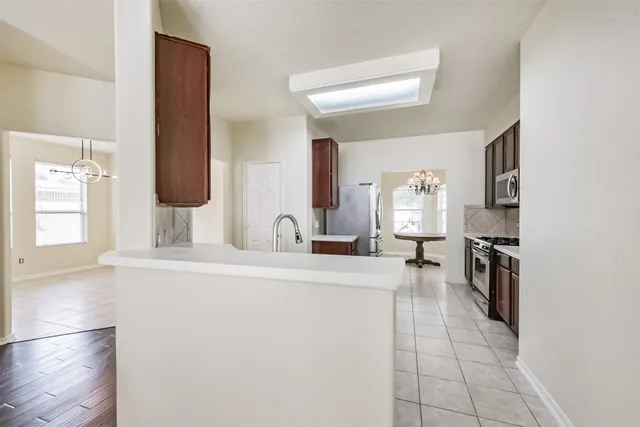 a kitchen with a sink and a refrigerator