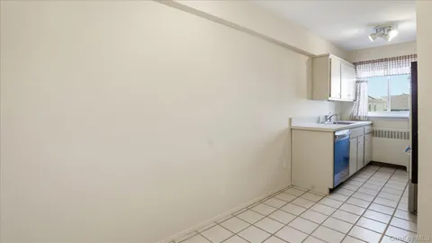 a kitchen with a sink a stove and cabinets