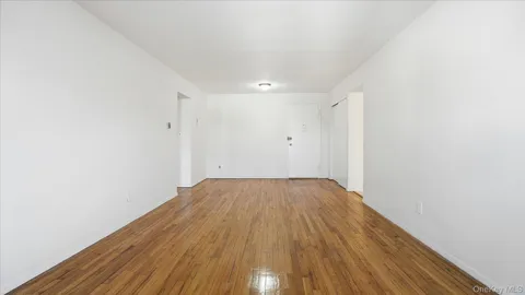 a view of a room with wooden floor