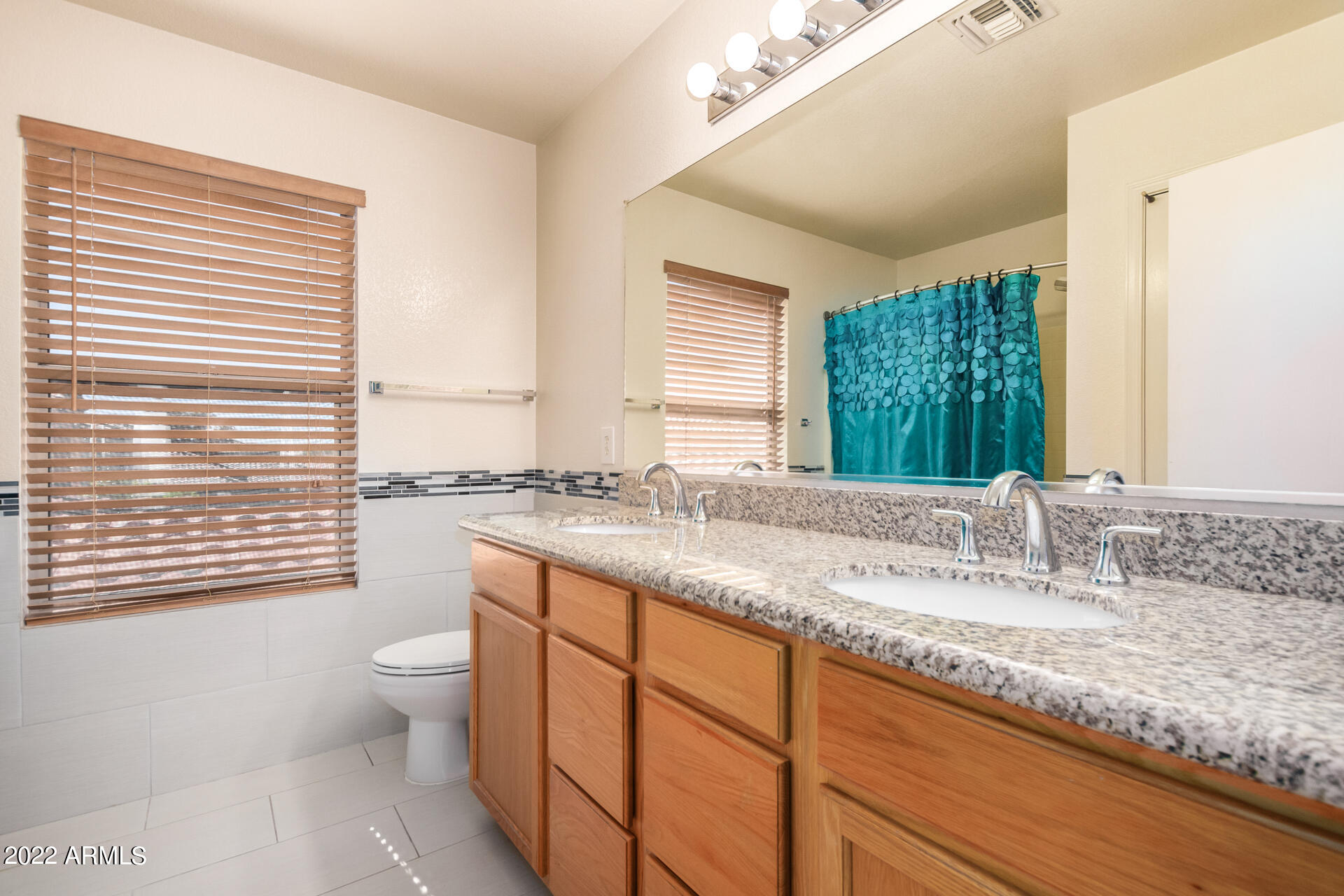 3307 South Bowman Road Apache Junction, AZ 85119 - Photo 15 of 28 a bathroom with a granite countertop sink and a large mirror