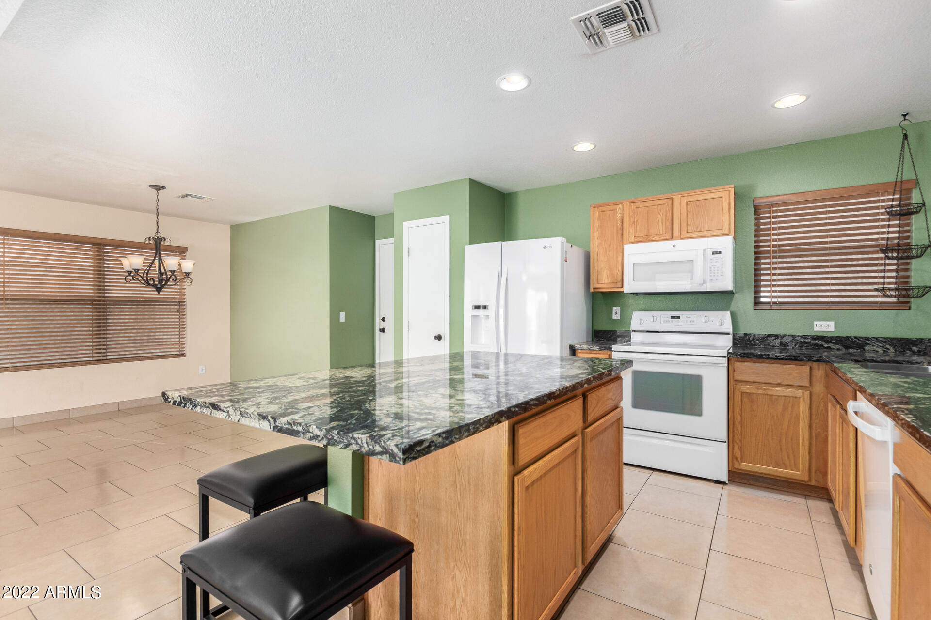 3307 South Bowman Road Apache Junction, AZ 85119 - Photo 9 of 28 a kitchen with stainless steel appliances granite countertop a sink stove and refrigerator