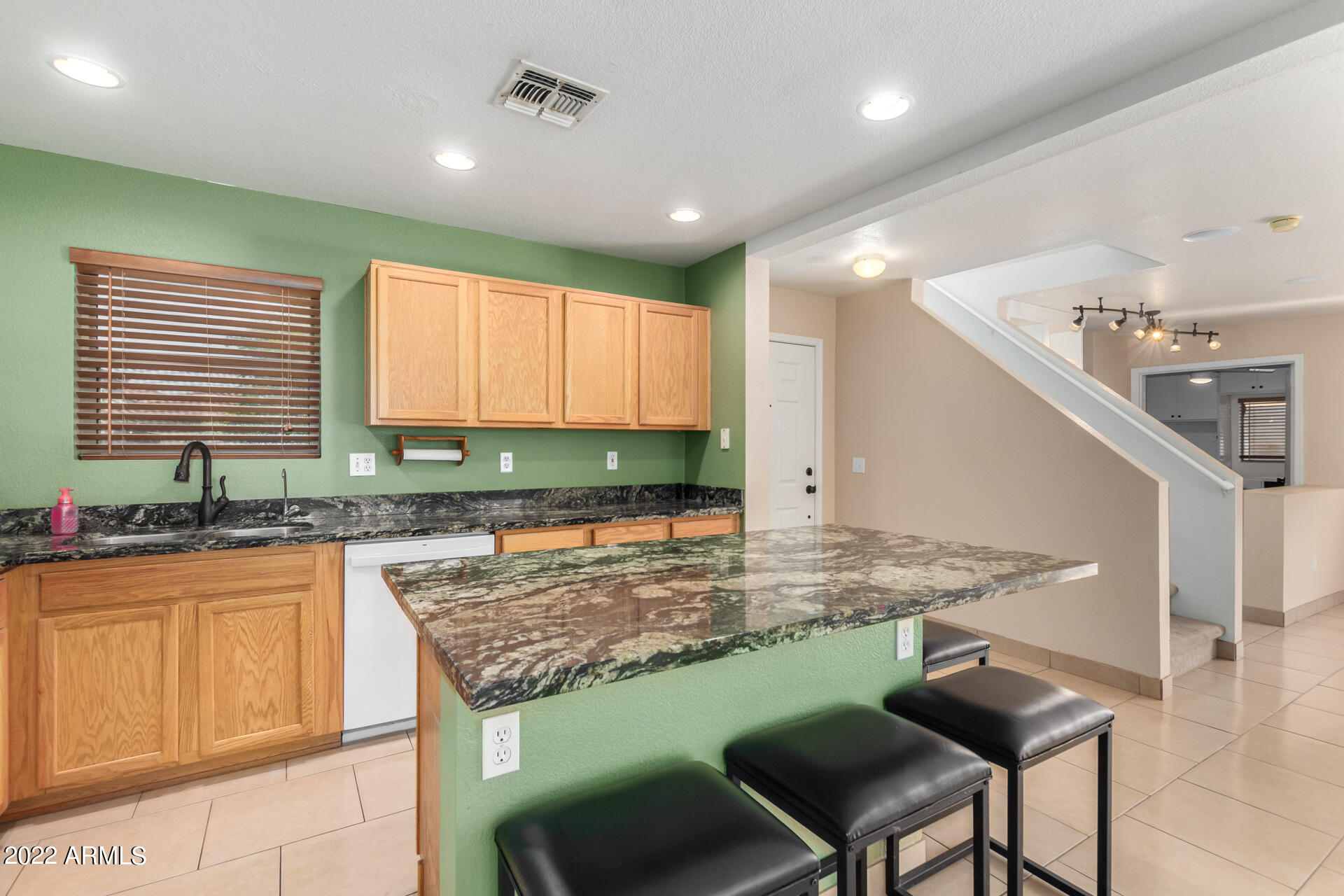3307 South Bowman Road Apache Junction, AZ 85119 - Photo 10 of 28 a kitchen with kitchen island granite countertop a stove a sink and a refrigerator