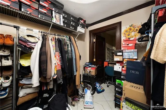 walk in closet with clothes and shoes