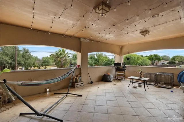 a building outdoor space with patio furniture and potted plants