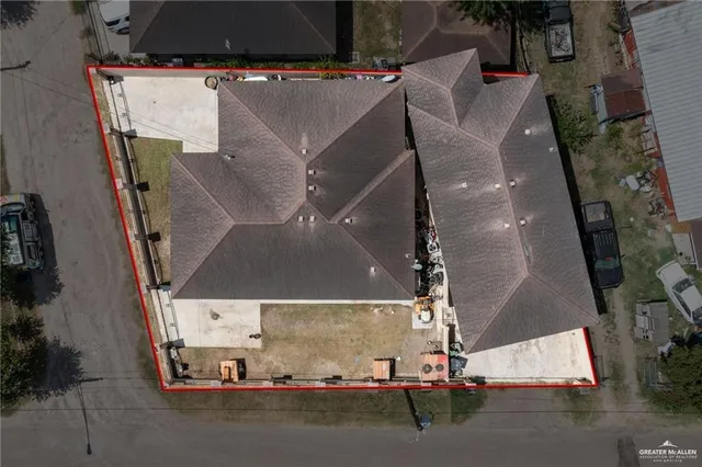 an aerial view of residential houses with outdoor space and river