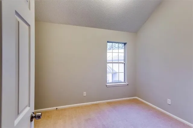 an empty room with closet area