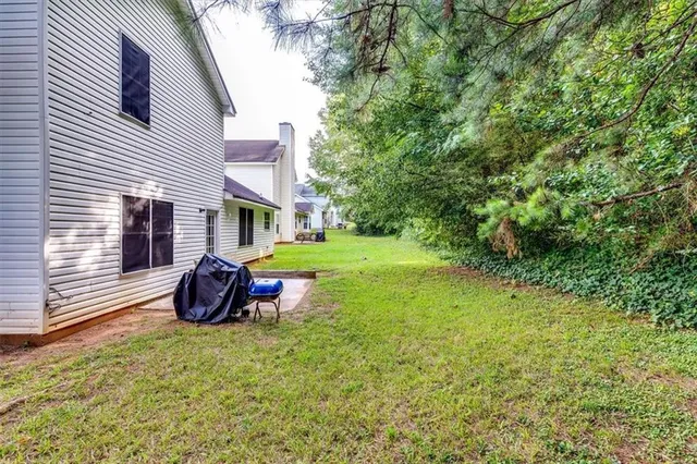 a view of a backyard with sitting area
