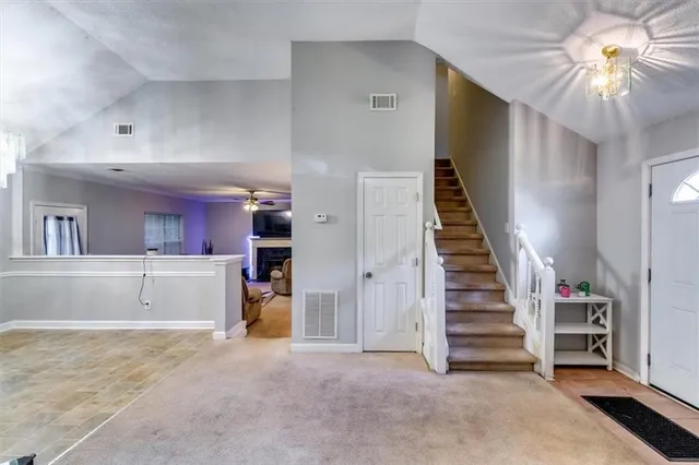 a view of a kitchen with granite countertop stainless steel appliances a stove a sink and a refrigerator