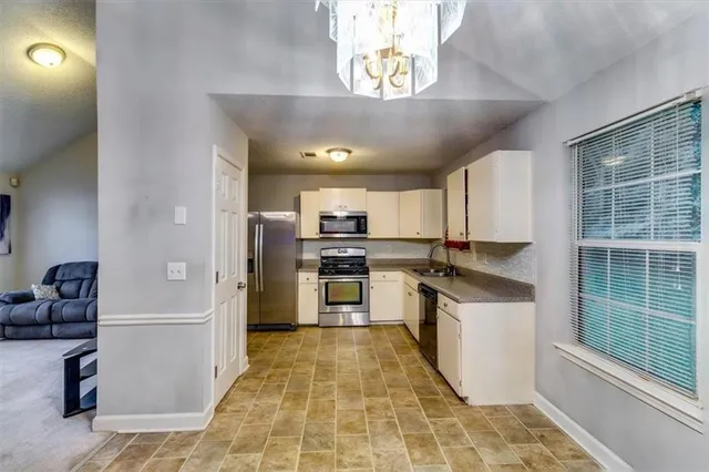 a view of a hallway with entryway to a bedroom