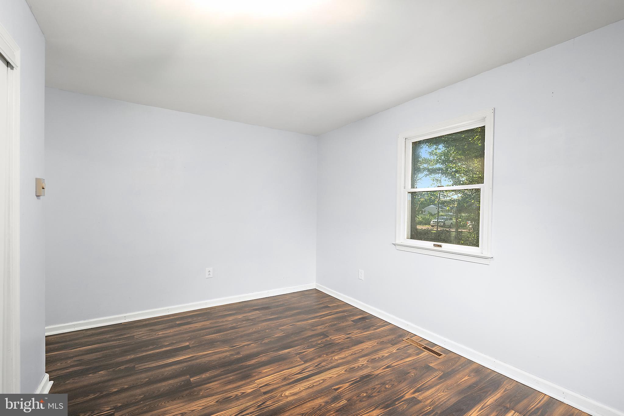 6181 Rockawalkin Road Salisbury, MD 21801 - Photo 34 of 65 an empty room with wooden floor and windows