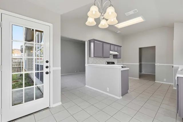 a view of kitchen with center island stainless steel appliances wooden floor and window