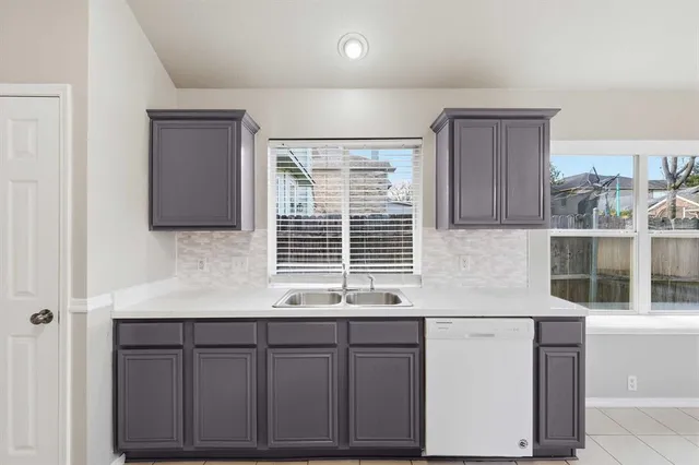 a kitchen with stainless steel appliances cabinets and window