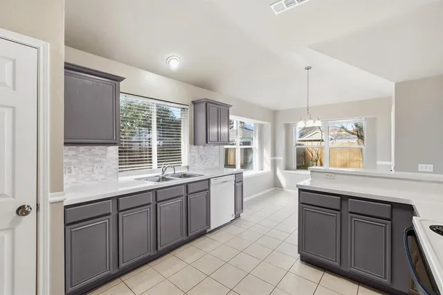 a kitchen with a sink and cabinets
