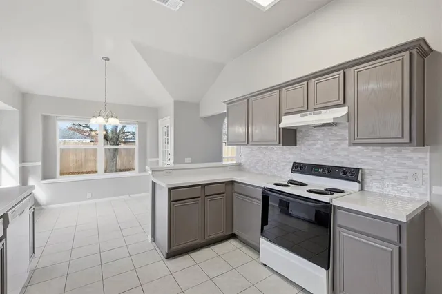 a kitchen with a stove sink and cabinets