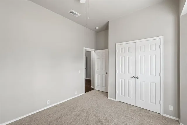 an empty room with closet area