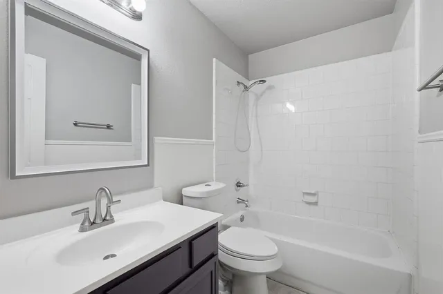 a bathroom with a sink mirror toilet and bathtub