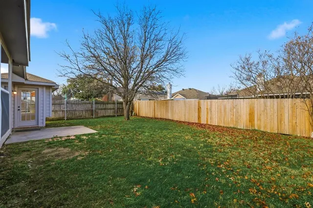a view of a backyard with large trees