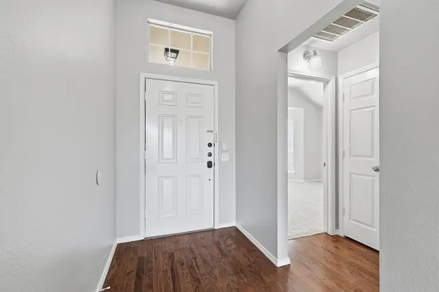 an empty room with wooden floor and closet