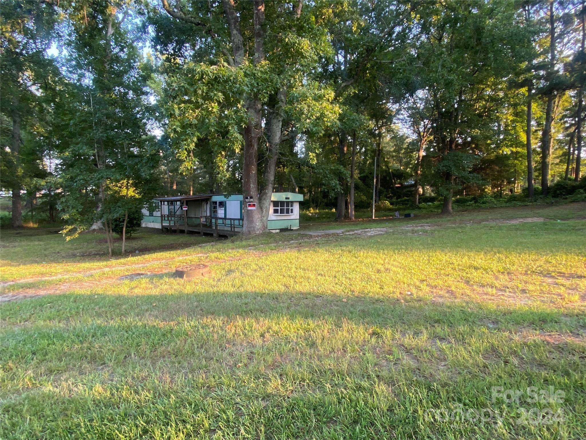 2126 Whaley Street Lancaster, SC 29720 - Photo 2 of 4 a swimming pool with outdoor seating and yard