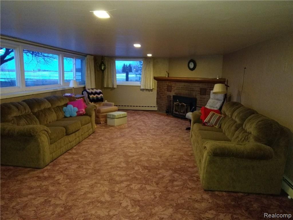 7565 Priemer Road Harbor Beach, MI 48441 - Photo 7 of 14 lower level family room with a fireplace