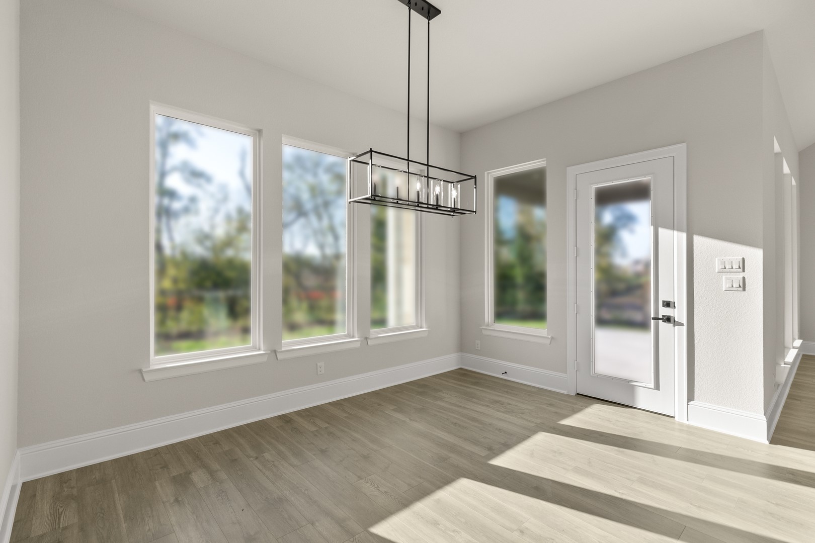 7914 Blue Dasher Pk Place Fulshear, TX 77441 - Photo 12 of 30 a view of a room with wooden floor and windows