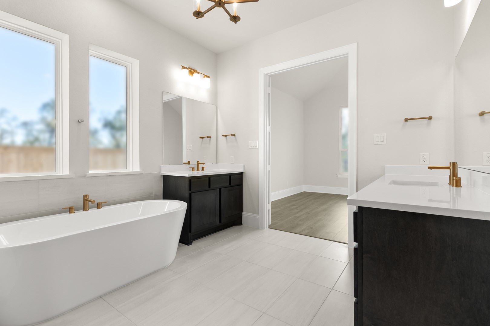 7914 Blue Dasher Pk Place Fulshear, TX 77441 - Photo 16 of 30 a bathroom with a double vanity sink a mirror and a bathtub