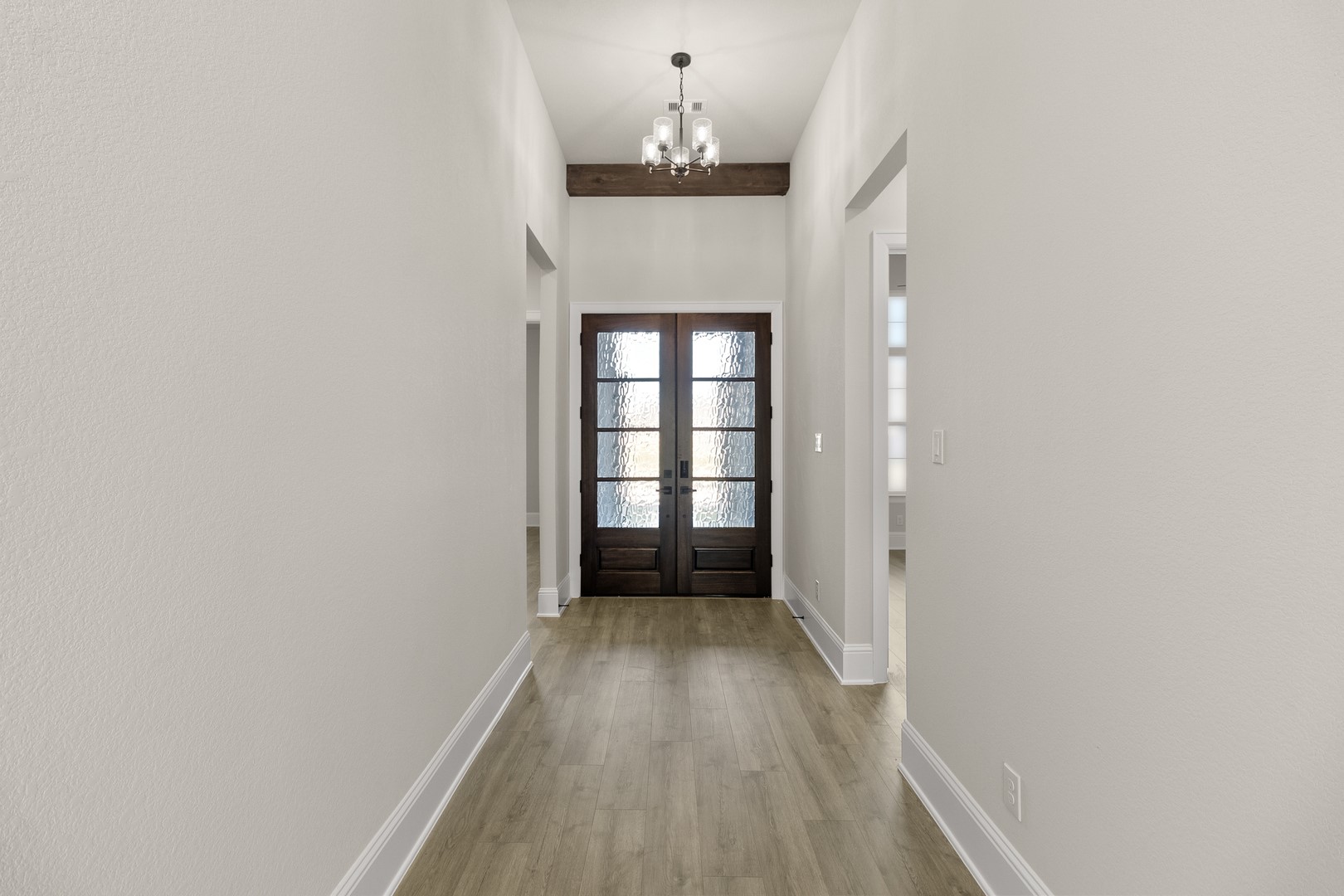 7914 Blue Dasher Pk Place Fulshear, TX 77441 - Photo 3 of 30 wooden floor in a hall with a window