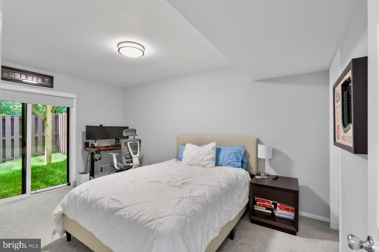 2224 Wheelwright Court Reston, VA 20191 - Photo 24 of 32 a bedroom with a bed wall painting and a window