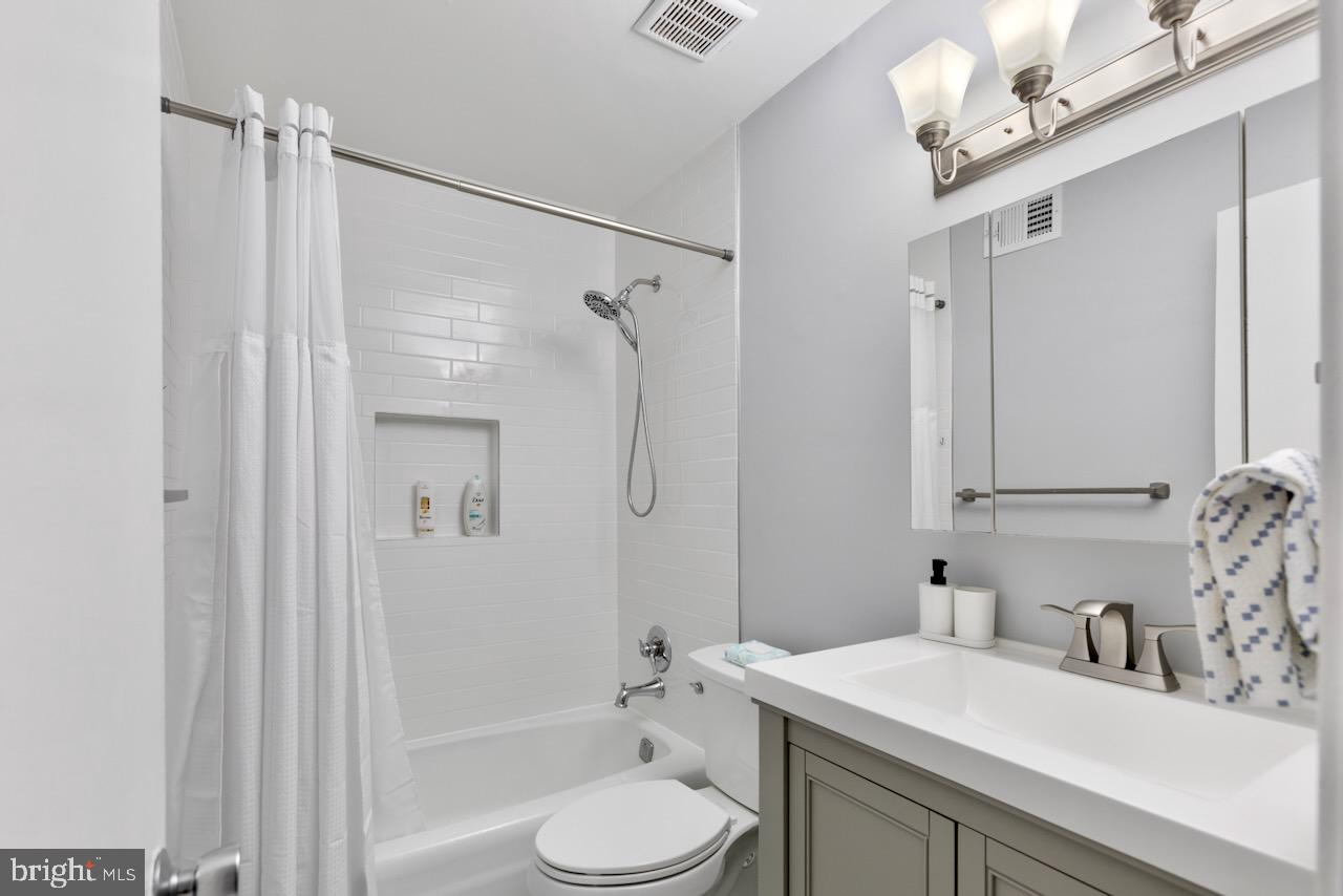 2224 Wheelwright Court Reston, VA 20191 - Photo 25 of 32 a bathroom with a sink toilet a mirror and shower