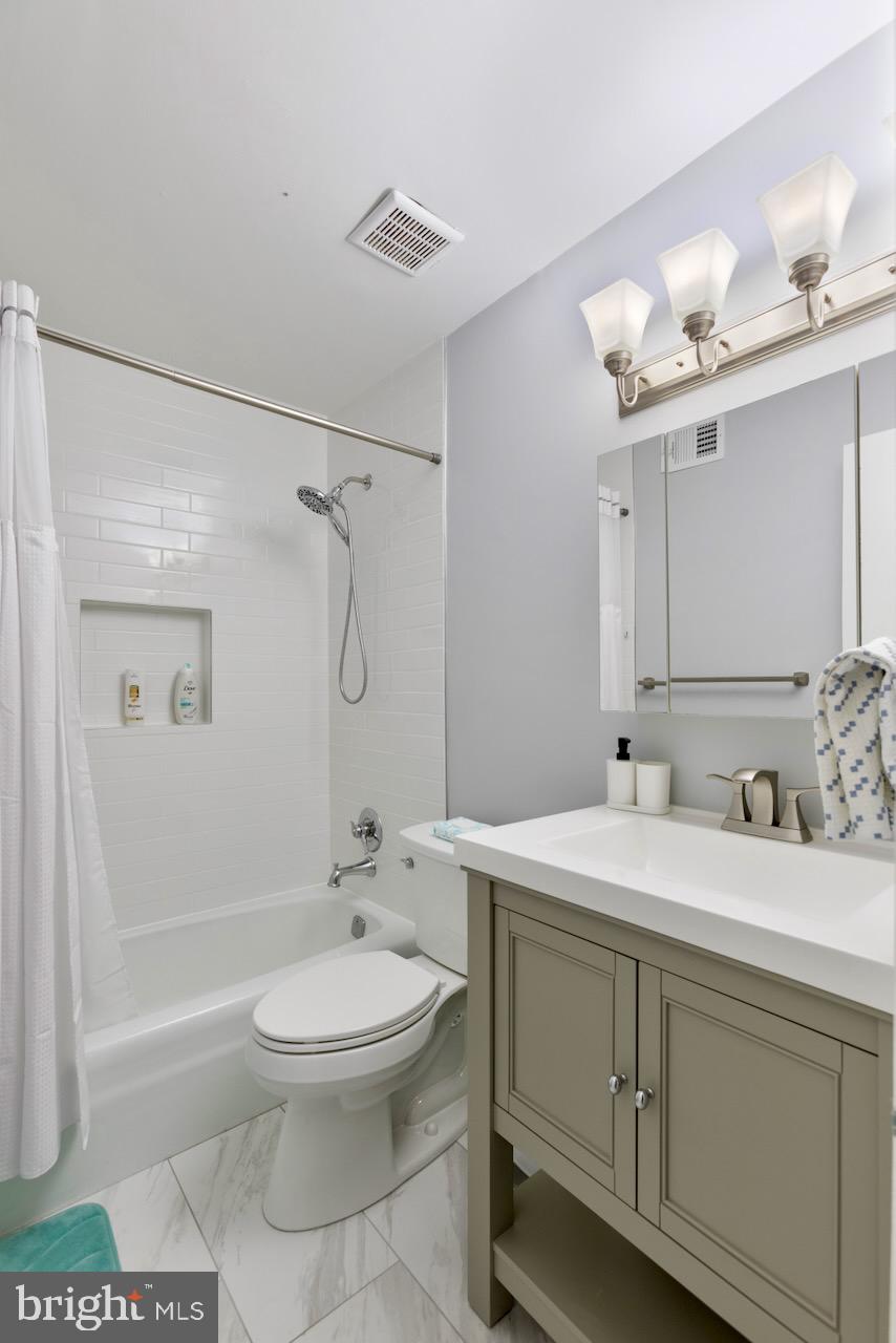 2224 Wheelwright Court Reston, VA 20191 - Photo 26 of 32 a bathroom with a sink toilet a shower and a mirror