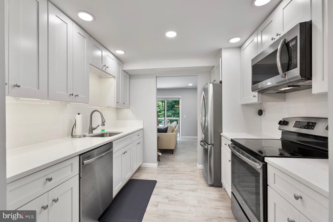 2224 Wheelwright Court Reston, VA 20191 - Photo 4 of 32 a kitchen with a sink stainless steel appliances and cabinets