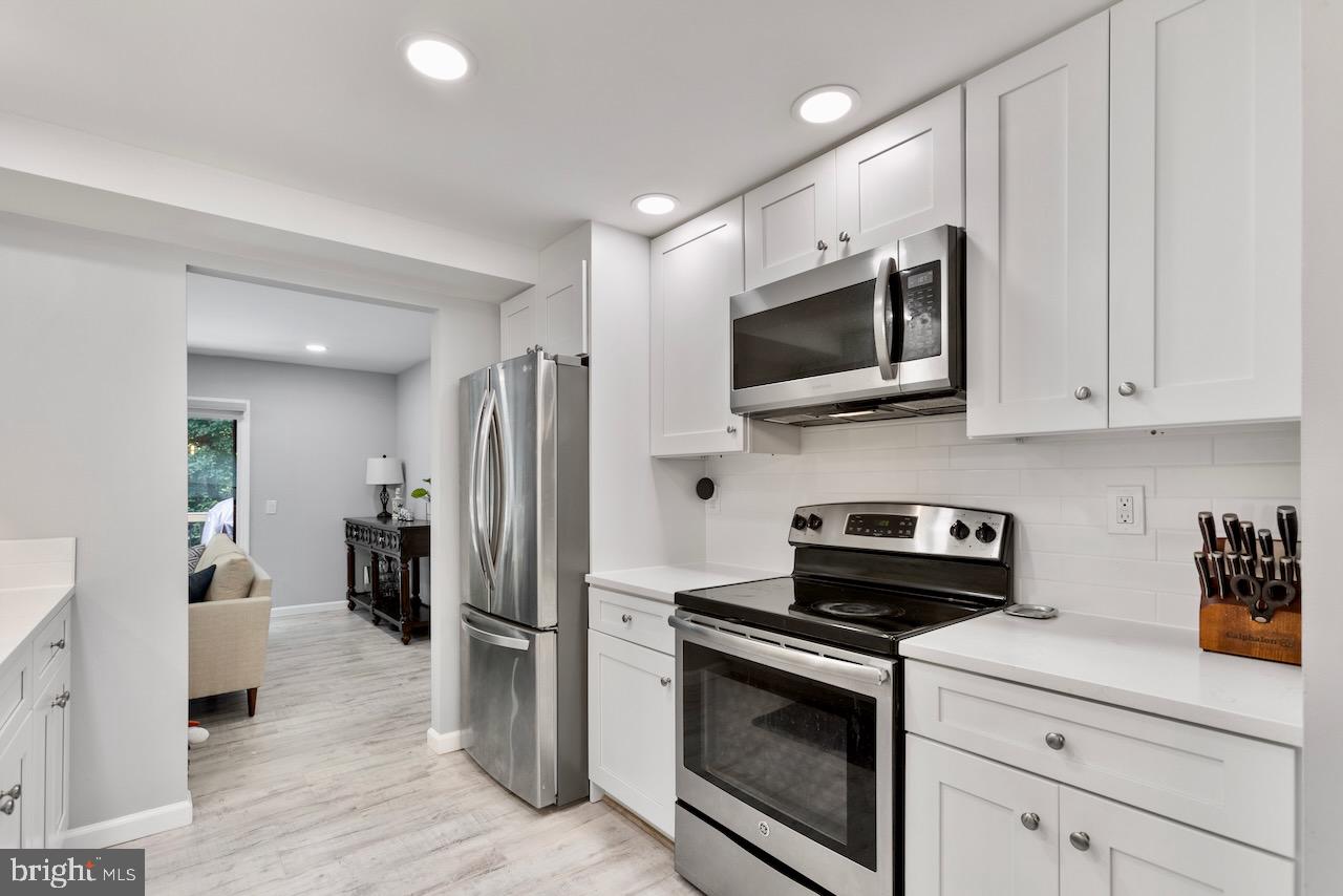 2224 Wheelwright Court Reston, VA 20191 - Photo 5 of 32 a kitchen with stainless steel appliances a stove microwave and refrigerator