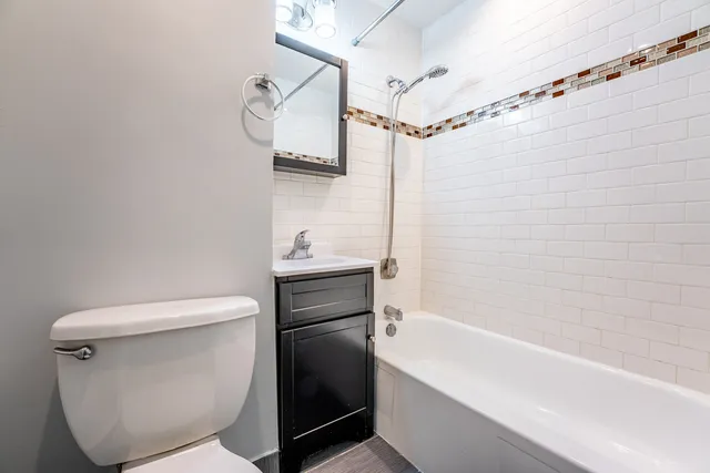 a bathroom with a toilet and a bathtub