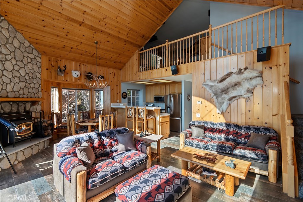 2477 Spring Oak Drive Running Springs, CA 92382 - Photo 14 of 51 a living room with furniture a fireplace and a flat screen tv