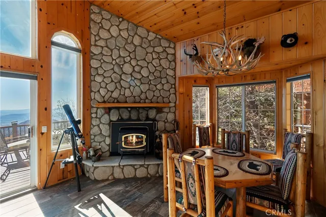 a view of a kitchen with stainless steel appliances kitchen island granite countertop a table and chairs in it