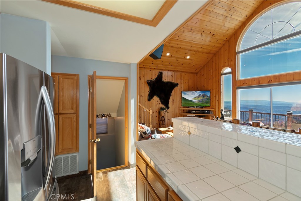2477 Spring Oak Drive Running Springs, CA 92382 - Photo 20 of 51 a large kitchen with a large window and stainless steel appliances