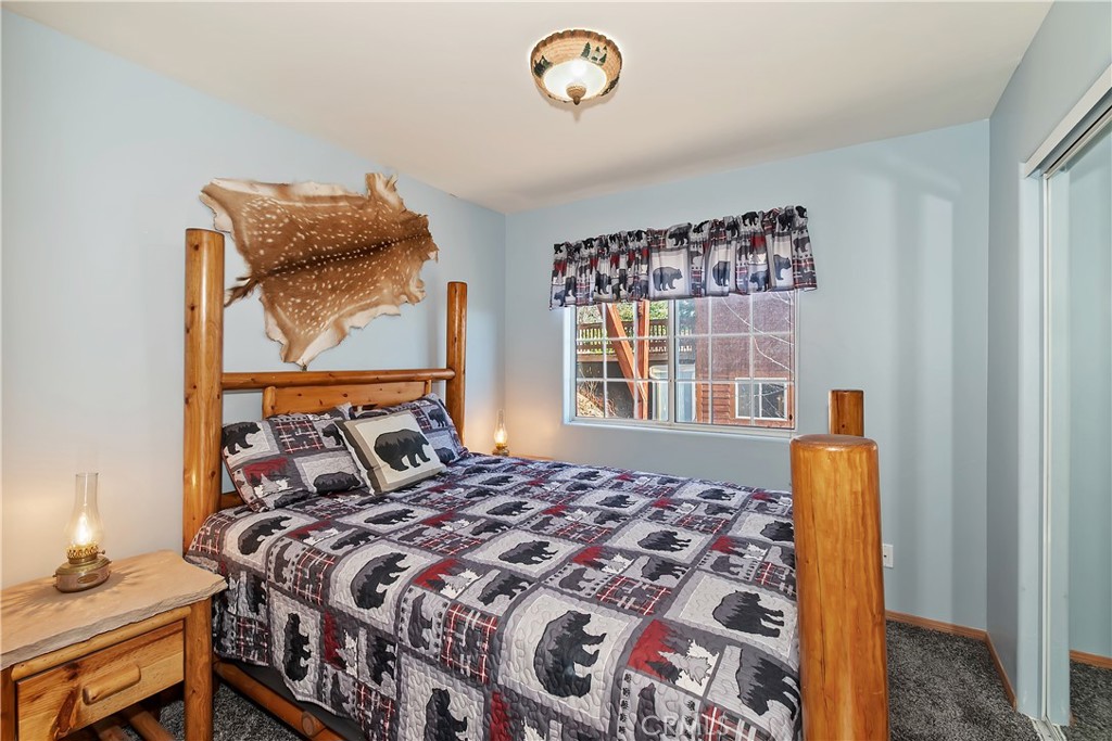 2477 Spring Oak Drive Running Springs, CA 92382 - Photo 24 of 51 a bedroom with a bed and a window